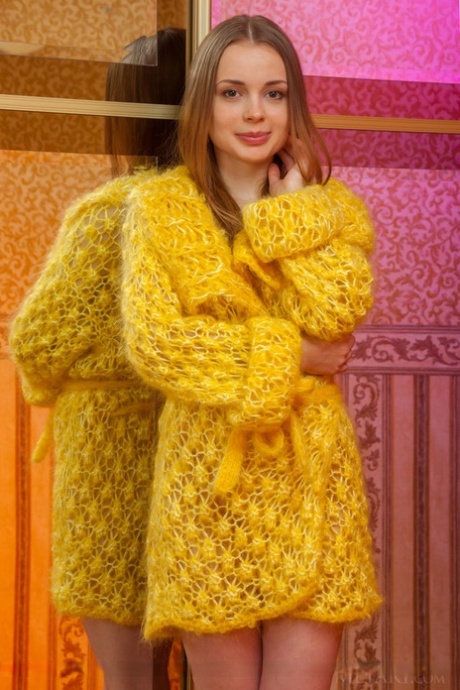 Adorable teen Winnie removes a yellow robe to pose nude in front of a mirror