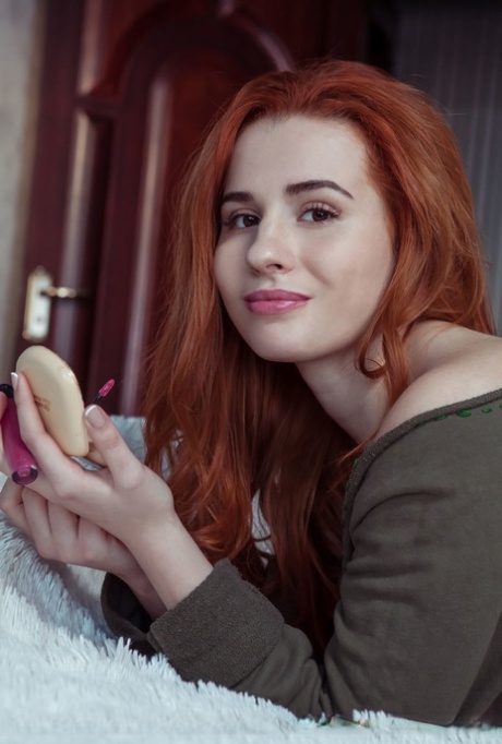 Young redhead Nicole La Cray highlights her perfect pussy while getting naked 69390817