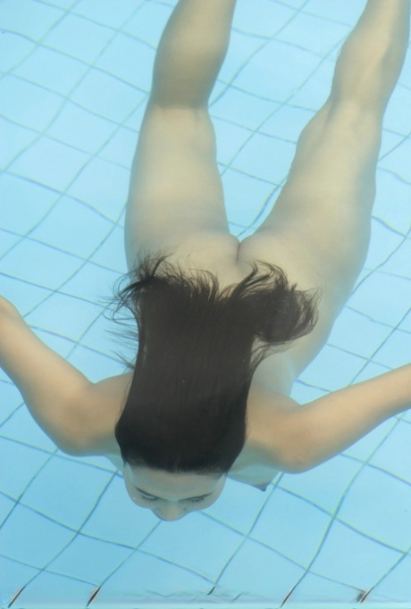Young Asian girl with firm tits and a full bush swims naked in a pool 57329355