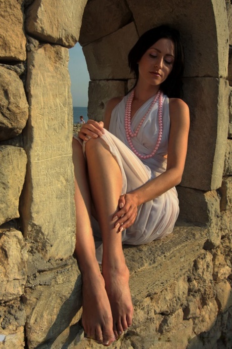 Pretty brunette Janelle B gets totally naked in an arid location 38727962