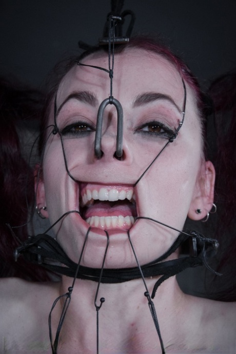 Redhead sub Ivy Addams is restrained and humiliated in a dungeon 49921393