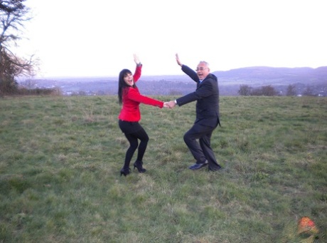 Dark haired woman dances with an old man in field before fucking indoors 50265936