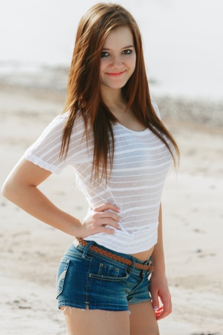 Fresh faced girl Emily French gets completely naked on a sandy beach 82677383