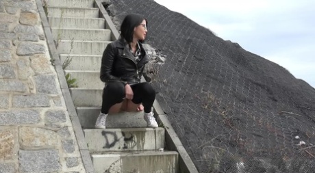 Dark haired girl Dee pulls down her leggings for a pee on concrete stairs 35901845
