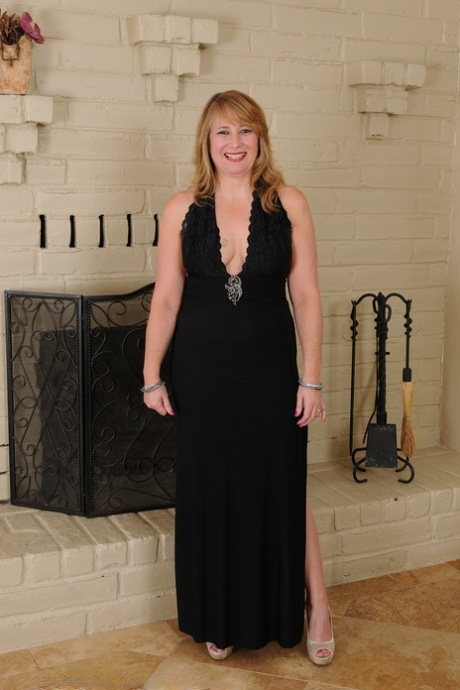 Older woman Catrina Costa cups boobs after getting naked by an unlit fireplace 12540997