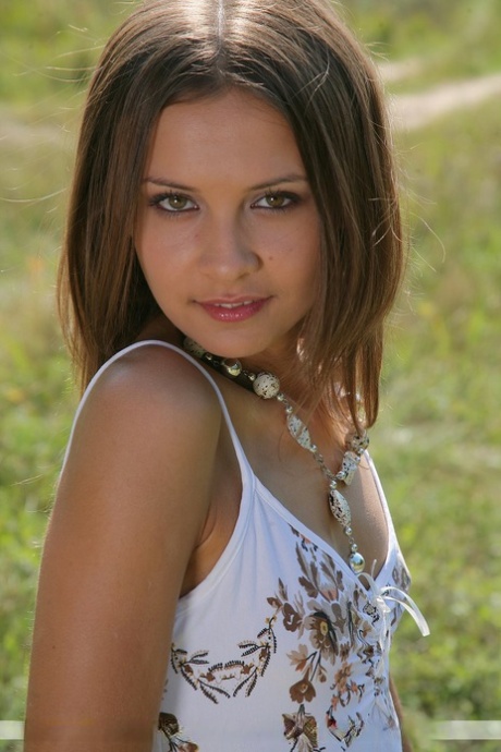 Petite white girl Rita B models naked in a farmer's field 14840393