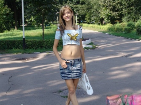 Skinny teen with long legs in short skirt looking sexy in public 20287381