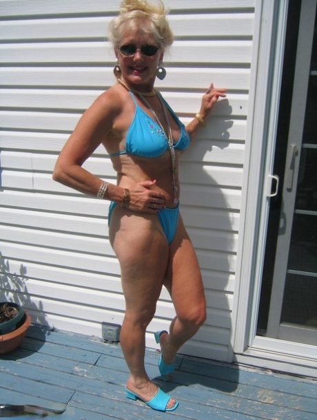 Mature blonde Ruth frees her tits and ass from a bikini in sunglasses 70377348