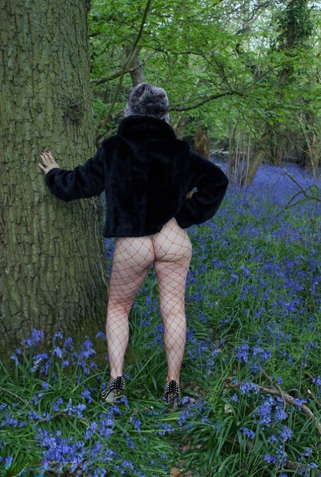 Mature lady removes her winter coat to show her big naturals in mesh pantyhose 18728979