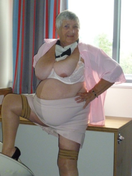 Obese old woman Grandma Libby lays her floppy tits on a desk while undressing 40661412
