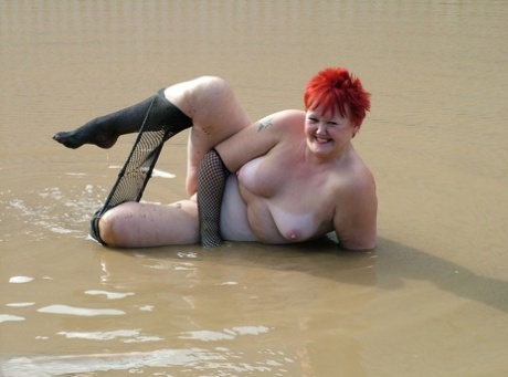 Fat redhead gets naked and naughty in a collection of outdoor nudes 12034249