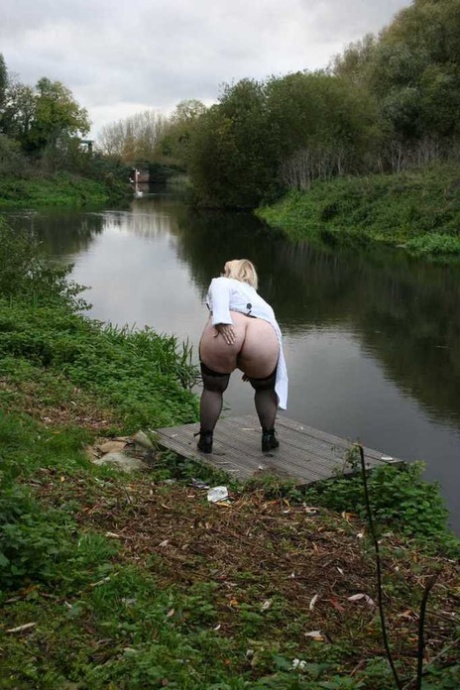 Obese blonde Lexie Cummings smokes while exposing herself on a path in a park 24713200