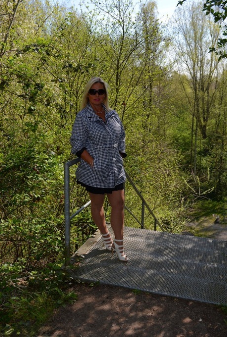 Middle-aged blonde Nude Chrissy exposes herself on a public walking path 96800739