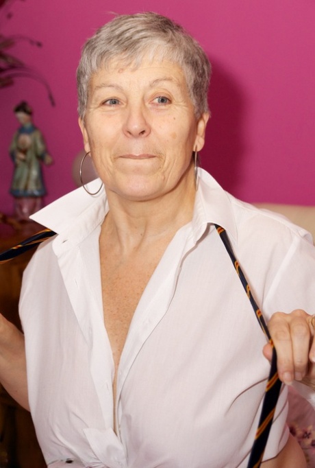 Short haired granny Savana removes schoolgirl clothing during solo action 17027584