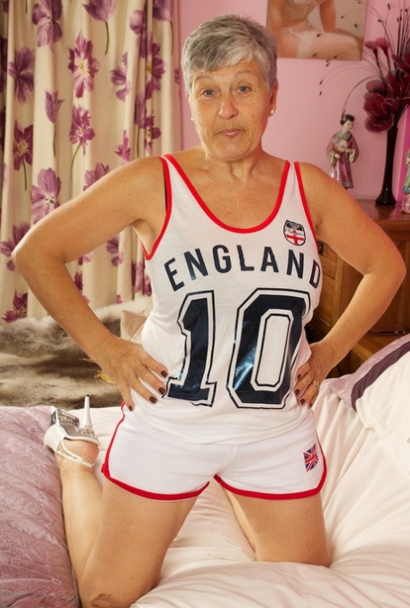 Short haired UK granny Savana uncovers her large tits on a bed in a thong 19216209