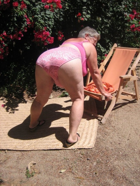 Obese granny Girdle Goddess strips to her sandals on garden patio 45517006