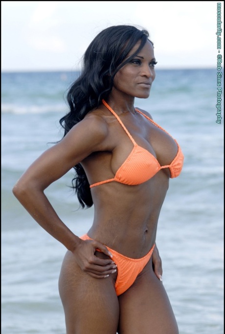 Ebony bodybuilder Debra Dunn poses at the ocean in a string bikini 92437490