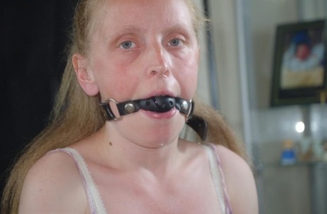 Caucasian female drools while sporting a ballgag in hose and heels 62949380