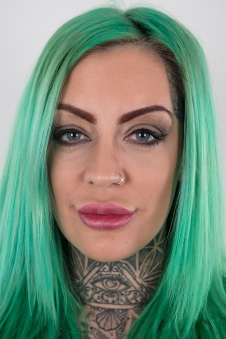 Tattooed girl with green hair and pierced nipples stands naked after disrobing 73761277
