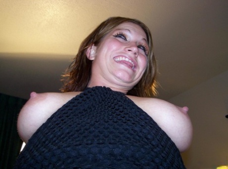 Amateur woman Toni exposes her boobs on a bed while wearing black boots 93764031