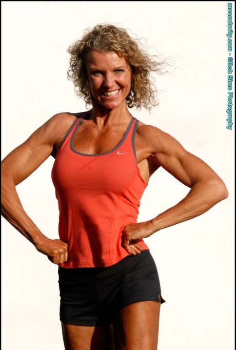 Bodybuilder Denise James flexes at the beach while wearing a bikini 24034989