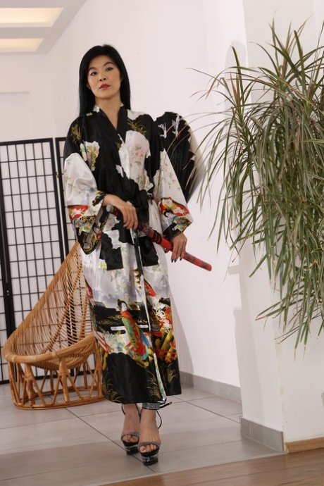 Tattooed Asian girl Akasha Coliun pisses herself after dildoing with nunchucks 68100507