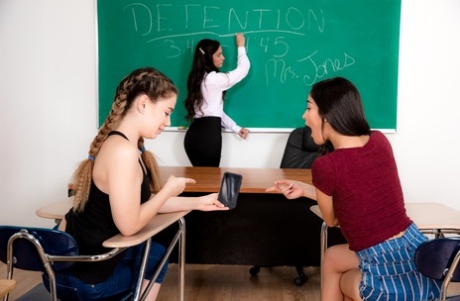 Two schoolgirls have a lesbian threesome with their teacher in a classroom 54631493