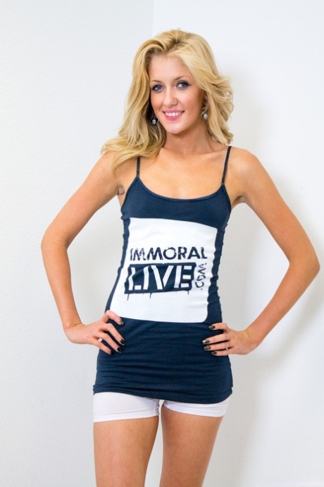 Blonde girl Emily Kae sports a nice smile while stripping to sports socks 42646369