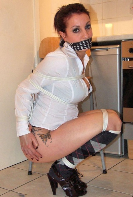 Clothed female manages to lose her pleated skirt while tied up and gagged 91397655
