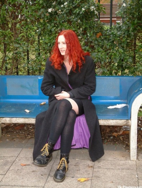 Redheaded girl plays with her hairless pussy on a bench in public 56608764