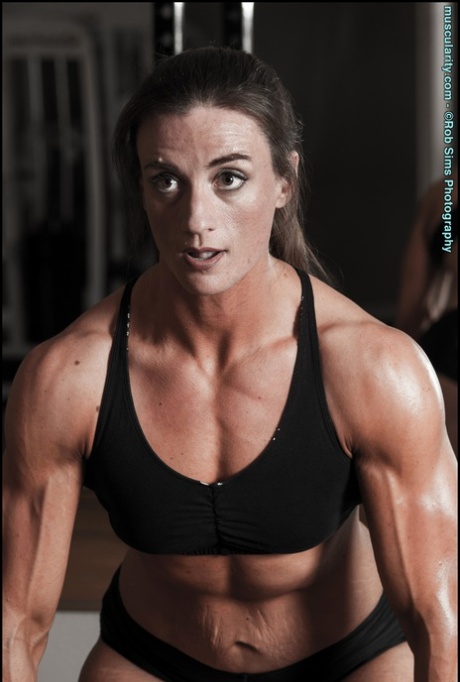 Bodybuilder Carrie Rapp models on a roadway before a weightlifting session 12208619