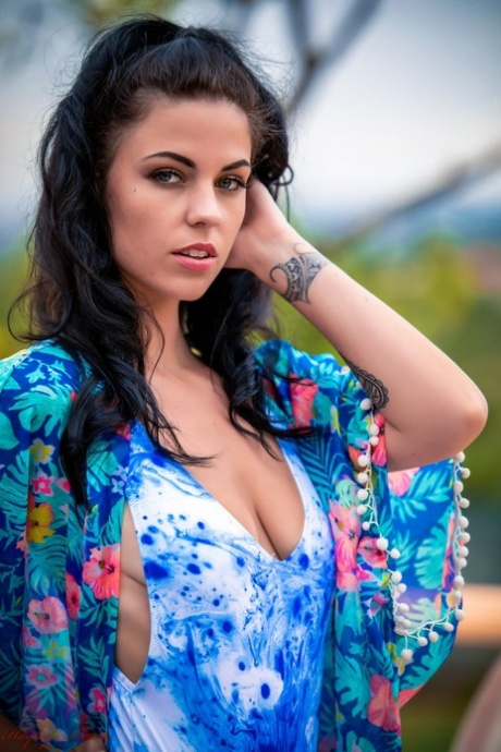 Brunette amateur Aemelia Fox uncovers small tits while getting nude on a patio 13473289