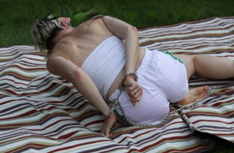 Caucasian woman is restrained with cuffs and chains in nylon shorts 57439403