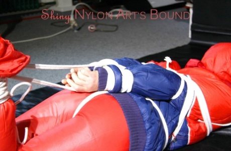 Caucasian chick is left tied, gagged and hooded on a sheet of black plastic 96257011