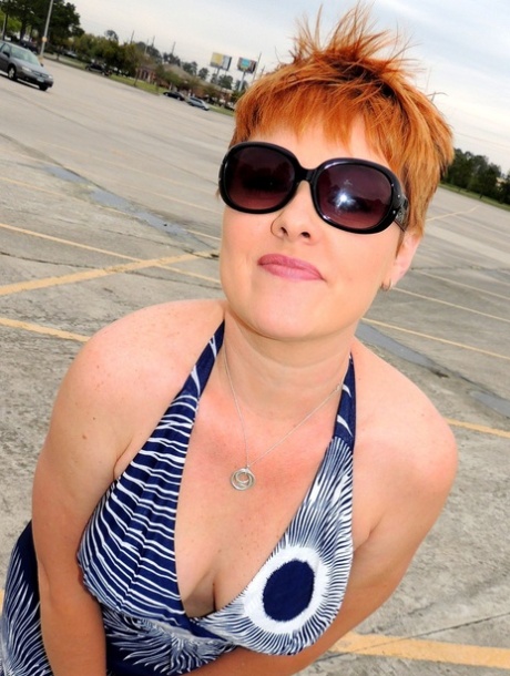 Middle-aged woman with short red hair has sex in a changing room 55817529