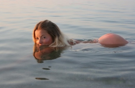 Naked blonde immerses herself in the ocean during a solo engagement 61352169