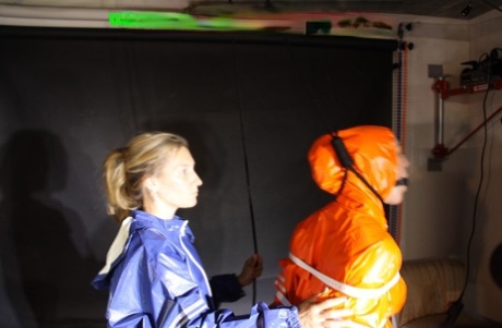 White girl is tied up and gagged during lezdom play in nylon rainwear 93410430