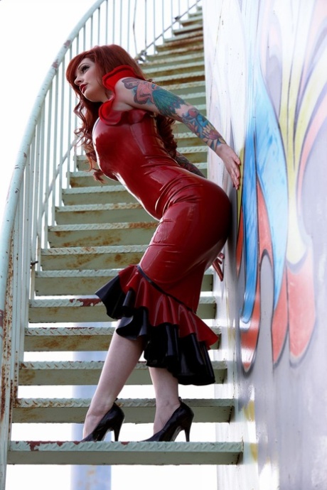 Gorgeous redhead Vanessa Lake works free of a long red latex dress in heels 20961907