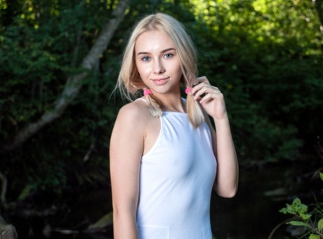 Young blonde Maya splashes water while kneeling naked in a creek 90952267