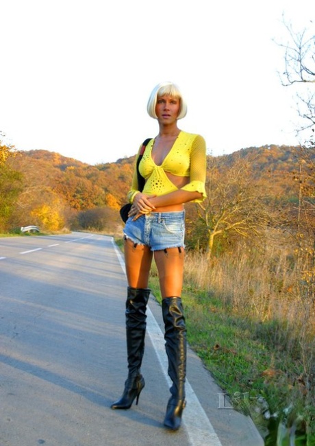 Hot blonde Lily Wow goes hitchhiking on a road in over the knee boots 27362152