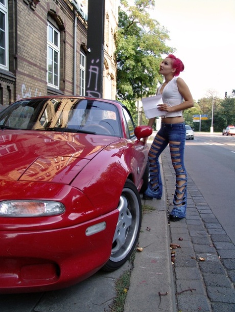 Flaming redhead is restrained in latex clothing by a lesbian 94078836