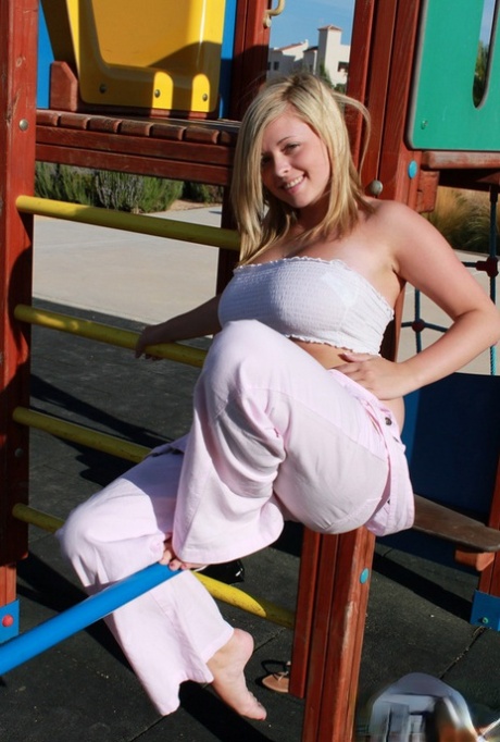 Blonde amateur Tegan Brady poses fully clothed on playground equipment 18328071