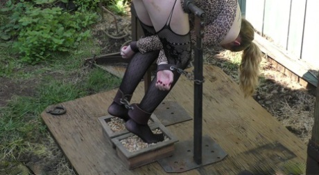 Blonde slave Jessica Kay chained on the porch for painful BDSM ass whipping 90190773