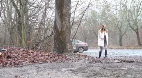 Solo girl Cynthia Vellons takes a piss in a gravel driveway on a wet day 40499877