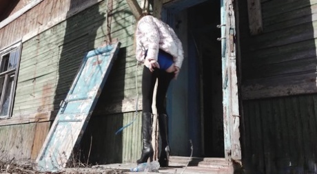 Solo girl Vika pulls down black leggings before squatting to pee by a building 33541438