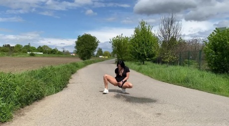 Brunette female Lexi Dona pees on a paved road in the countryside 95415411