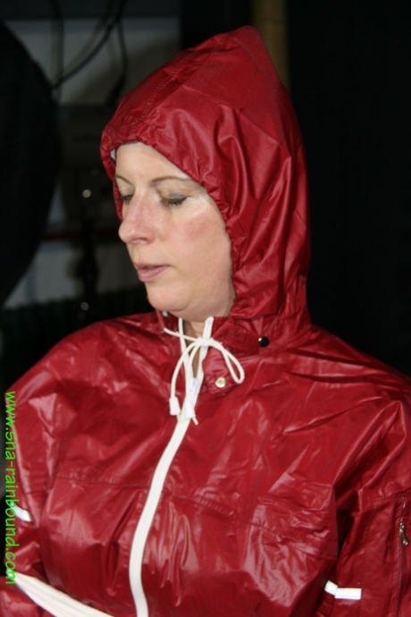 Amateur model Pia is tied to a hairdresser chair in a raincoat while gagged 13051879