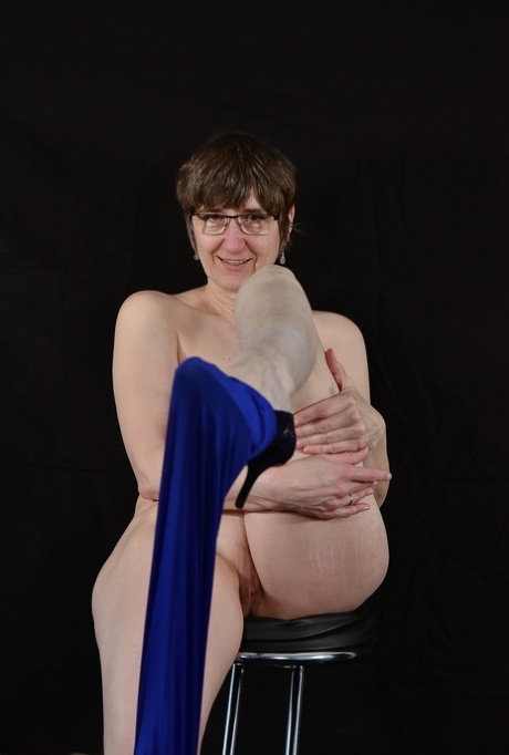 Older brunette Hot MILF unzips from a shiny bodystocking to go nude in glasses 47320497