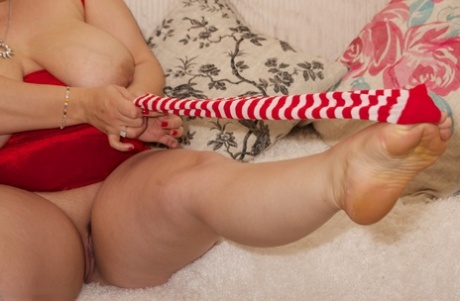 Older blonde BBW plays with her pink pussy in candy cane knee socks 44805272