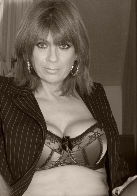 Sexy MILF Dimonty models for a tease shoot with her blazer unbuttoned 89269186